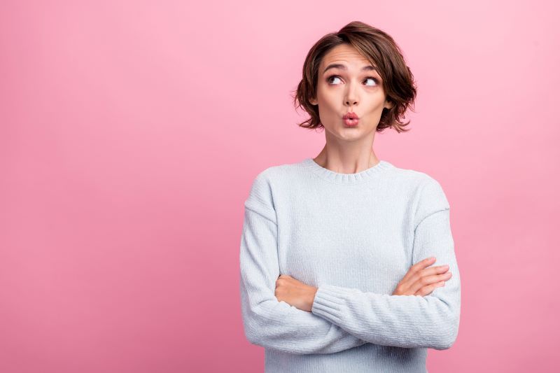 Dark haired woman looking up excited about the colour and style consultant course